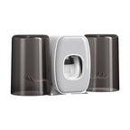 Toothbrush holder with two cups and a toothpaste dispenser