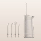 Portable cordless water flosser with four nozzles on a soft neutral background
