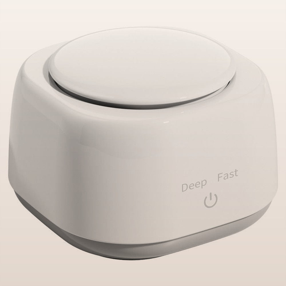 Mini ultrasonic cleaner on a warm neutral background